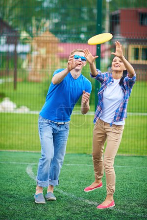 Couple playing with flying disc