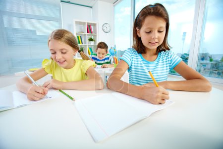 Schoolgirls drawing at workplace