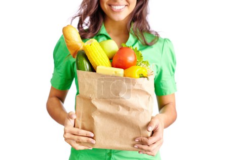 Girl with packet full of fruits and vegetables