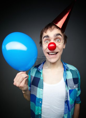 Guy hwith balloon  smiling crazily