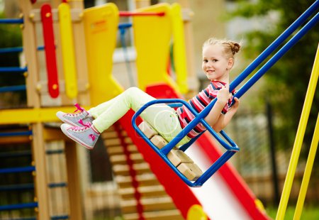 Girl swinging on playground