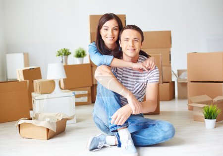 Couple sitting on the floor of new house