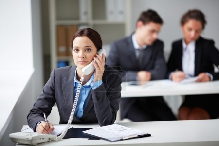 Smart businesswoman calling on phone