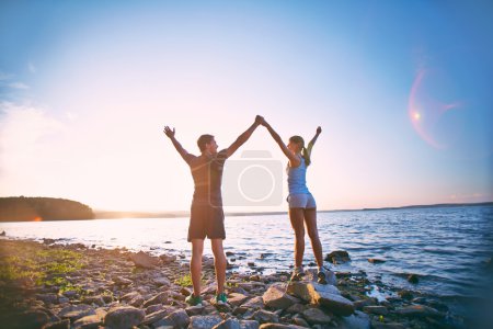 Couple standing on coastline