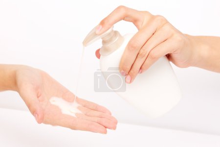 Hands pumping liquid soap