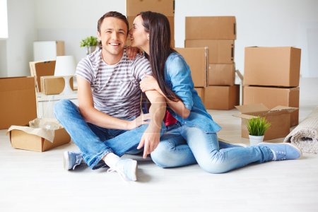 Couple sitting on the floor of new house