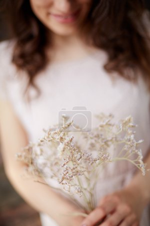 Woman with dry flowers