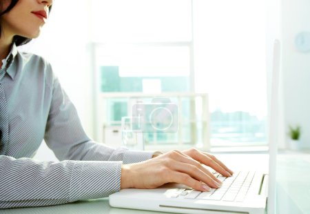 Business lady typing on laptop