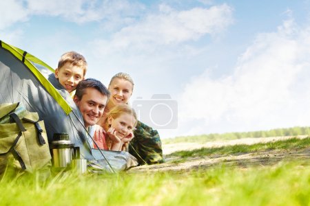Family of travelers in tent
