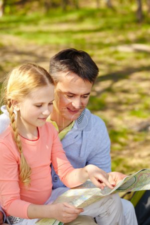 Man and daughter looking at map