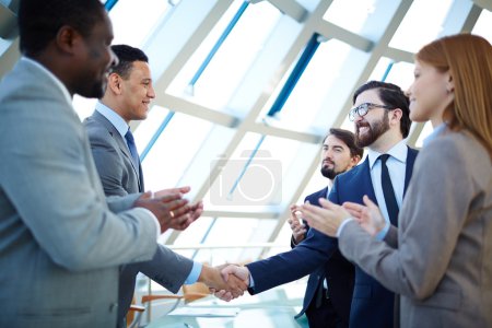 Business people congratulating colleagues