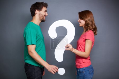 Couple holding paper question mark