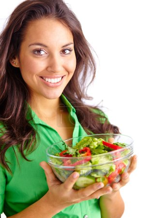 Girl holding bowl of fresh vegetable salad