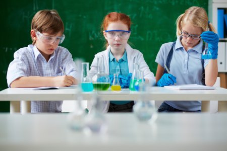Children working with chemical liquids