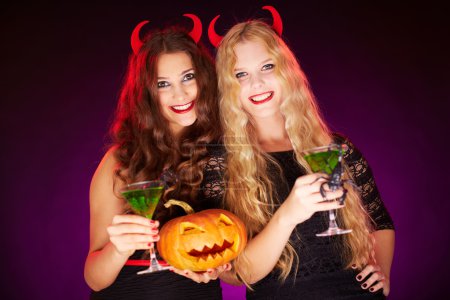 Females holding Halloween pumpkin