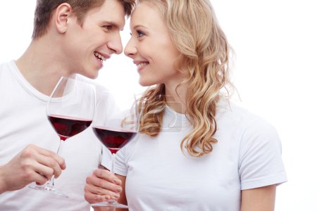 Couple holding glasses with red wine