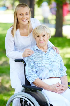 Nurse and senior patient in a wheelchair