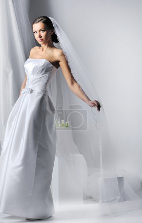 Young beautiful woman wearing luxurious wedding dress