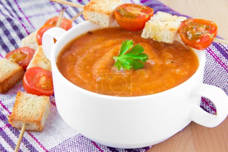 Vegetable cream soup with tomato and toast
