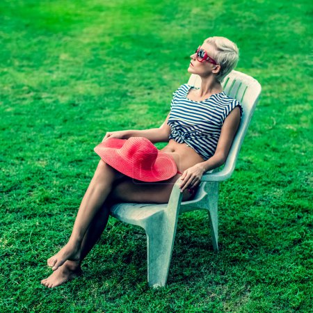 fashion girl sitting resting on a chair in the park