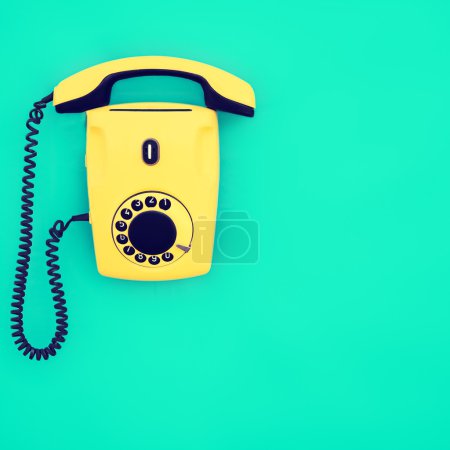 yellow retro telephone on a blue background