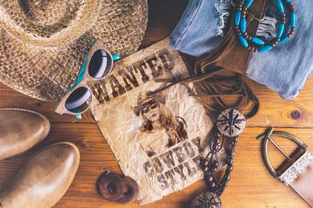 Accessories cowboy retro style on wooden surface with wanted pos