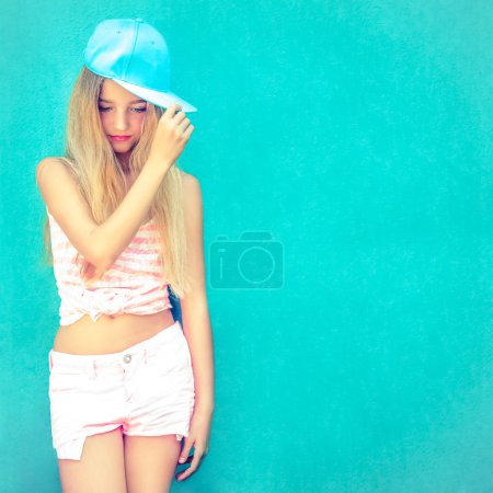 Portrait of cute teen girl in blue wall