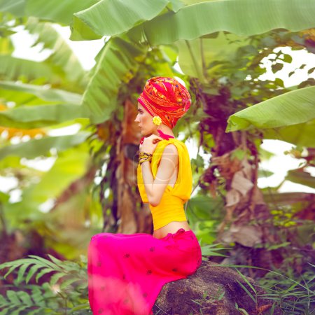 Oriental girl in a tropical jungle