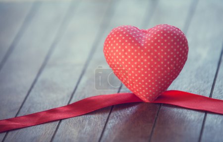 Heart and bow on wooden table