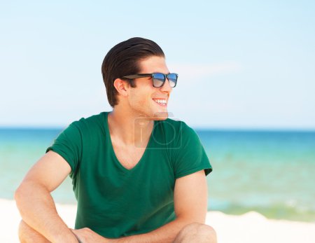 Handsome young man at beach background