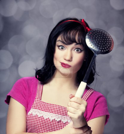 Brunette housewife with soup ladle