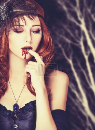 Redhead vampire woman in mask