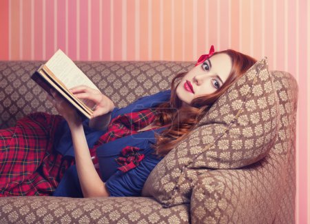 Women in 70s style reading book on the sofa