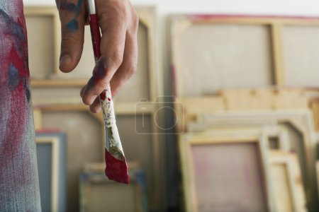 Artist holding paint brush 