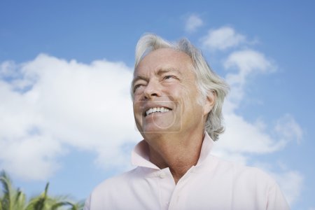 Man smiling against sky
