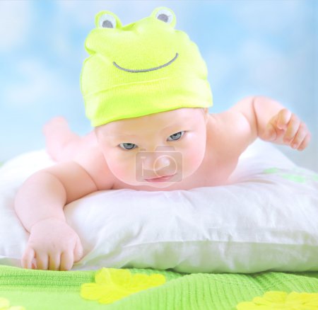 Little baby in frog costume