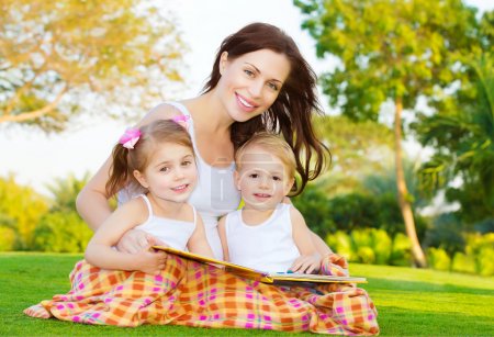 Mother with children read book