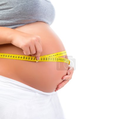 Expectant female measuring tummy