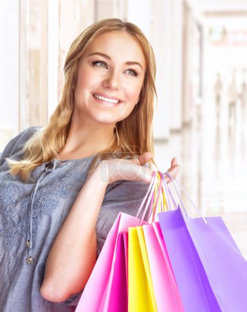 Cheerful girl with shopping bags