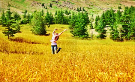 Girl jumping on wheat field