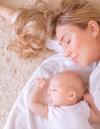 Newborn child sleeping with mom