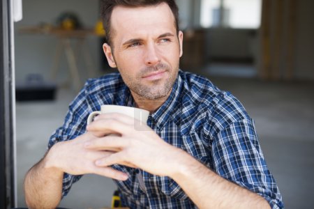 Construction worker drinking coffee