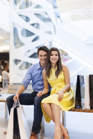 Smiling couple in shopping mall