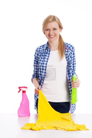 Young woman cleaning stained shirt
