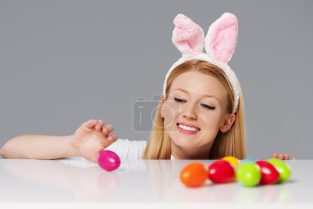 Cute bunny woman with easter eggs