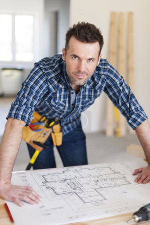 Construction worker with home plans