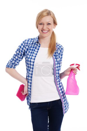 Blonde female cleaner holding a sponge and spray