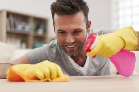Smiling man cleaning