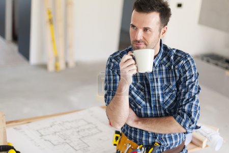Worker relaxing with cup of coffee