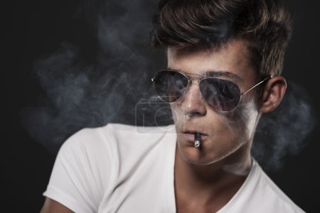 Handsome man smoking cigarette